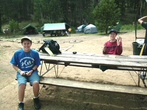 Garret and Jason carving wood for the wood carving merit badge.