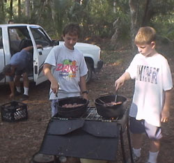 Dennis Milechin & Ben Keller working on Cooking merit badge.