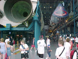 The boys are dwarfed by the Saturn V rocket.